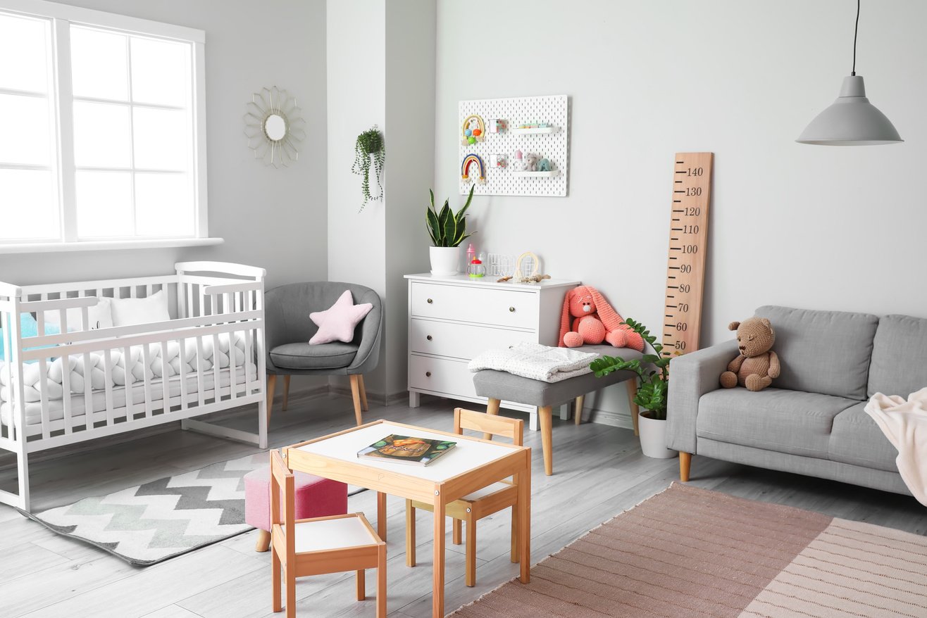 Interior of Stylish Children's Bedroom with Crib, Sofa and Pegboard